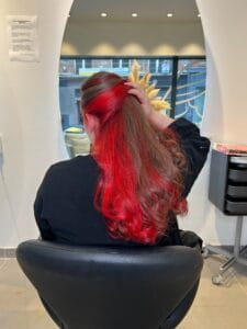 Underlight rouge cerise à la nuque sur cheveux bruns